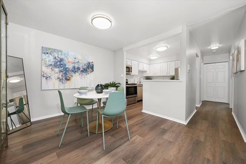 a dining room and kitchen with a table and chairs at Hampton in Highland Apartments, Highland