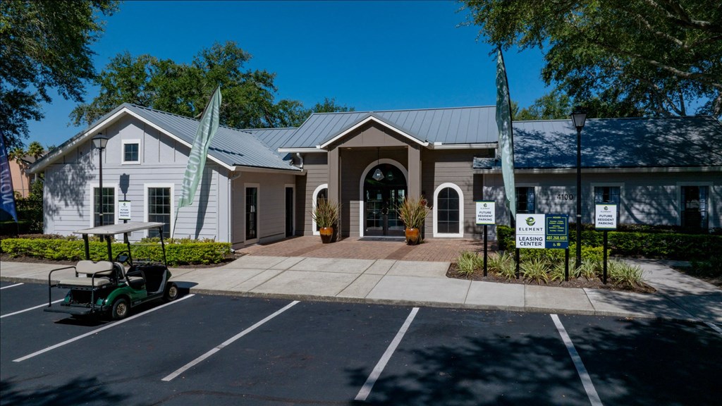 a white house with a golf cart parked in front of it