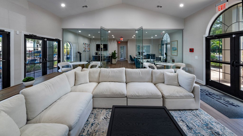 a large living room with a large white couch and a coffee table