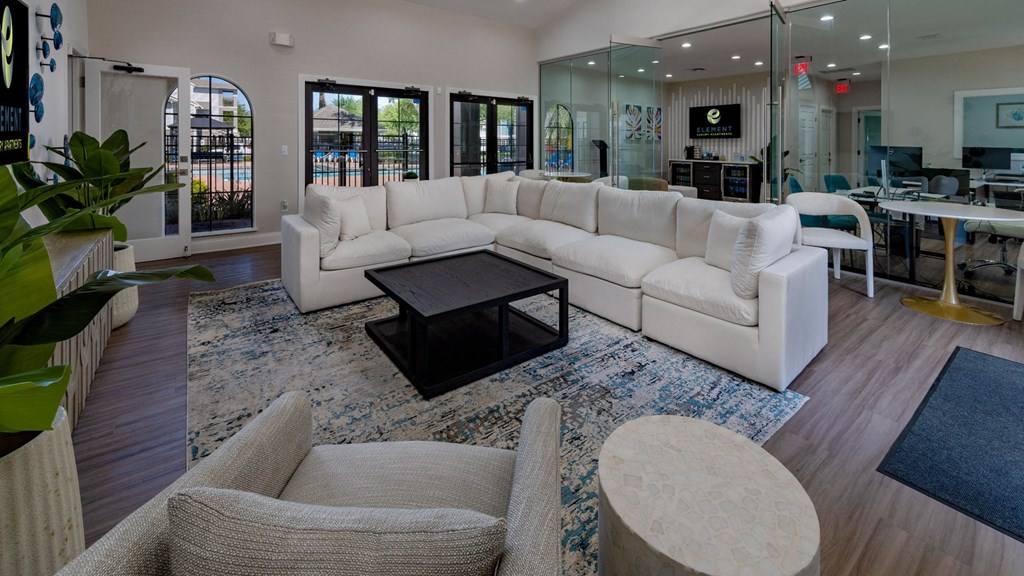 a large living room with white couches and a coffee table