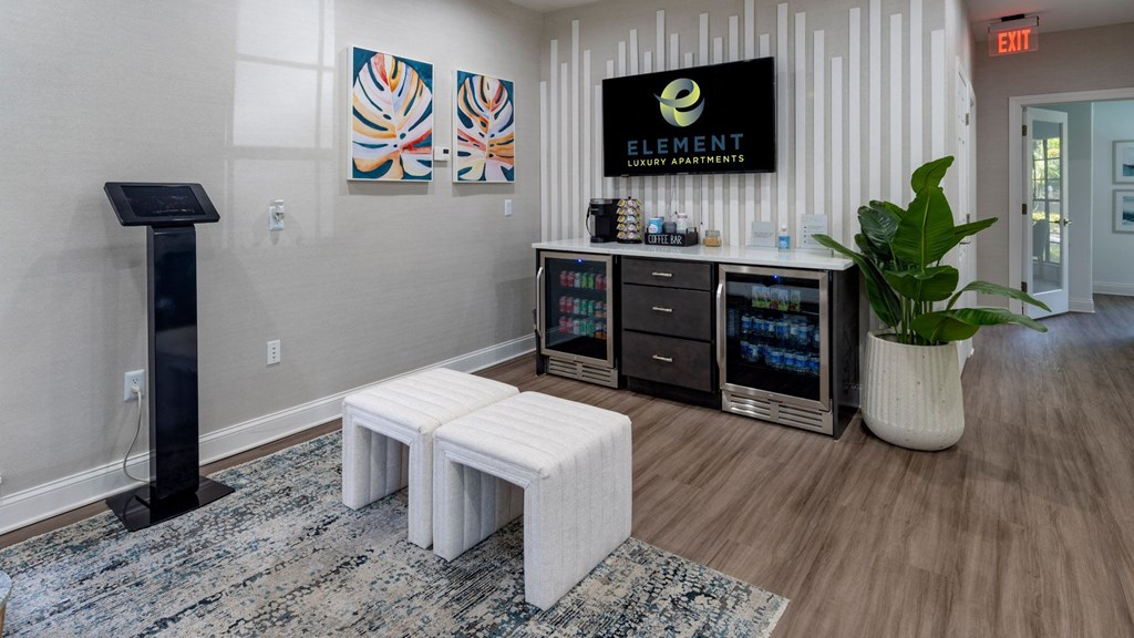a room with two stools in front of a counter with a plant and a