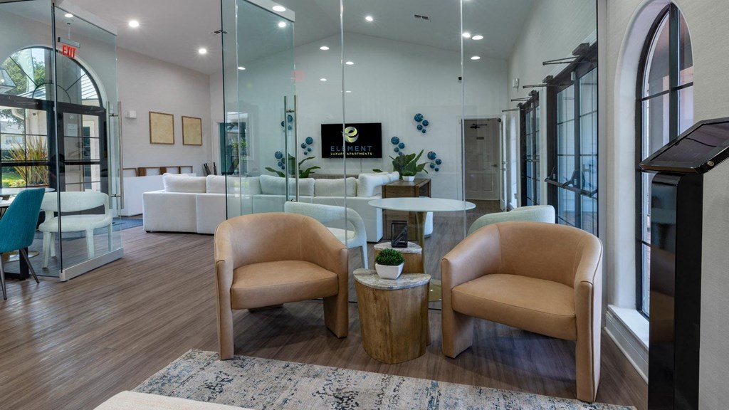 a living room with two chairs and a table