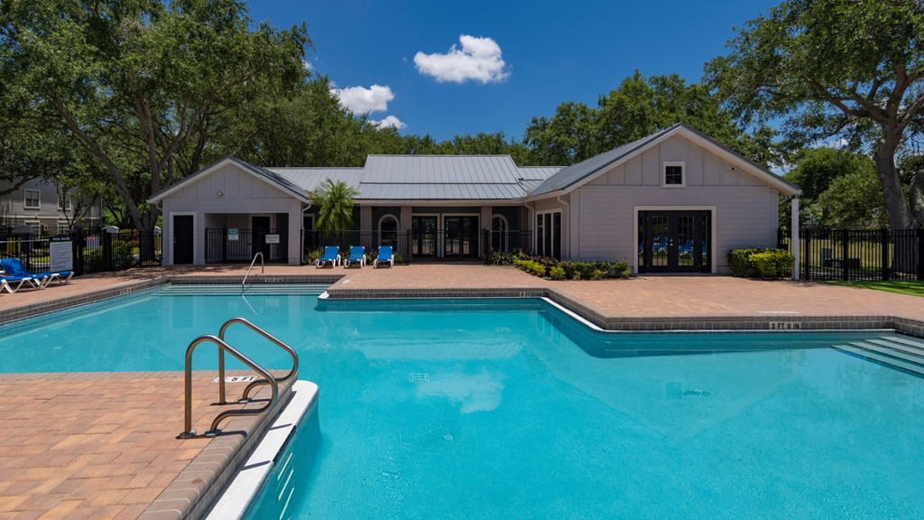 a swimming pool with a house in the background