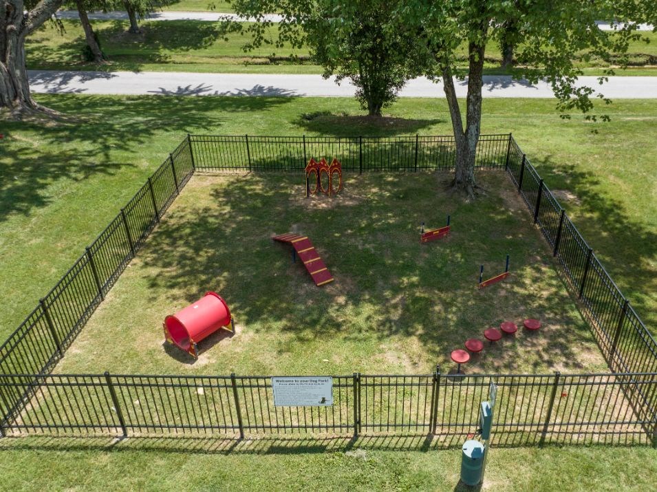 an aerial view of a dog park with a dog kennel and playground equipment at Stonewater Apartments, Louisville
