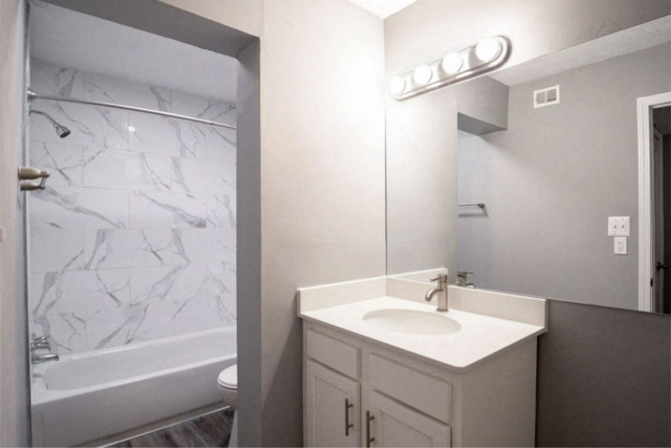 a bathroom with a sink and a bathtub at Station JTown, Louisville, KY 40299