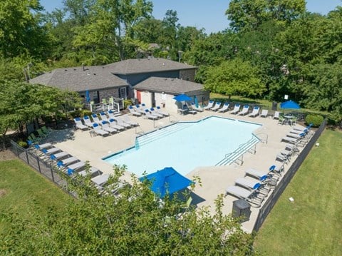 an aerial view of a resort style pool with lounge chairs and umbrellas at Station JTown, Louisville, KY