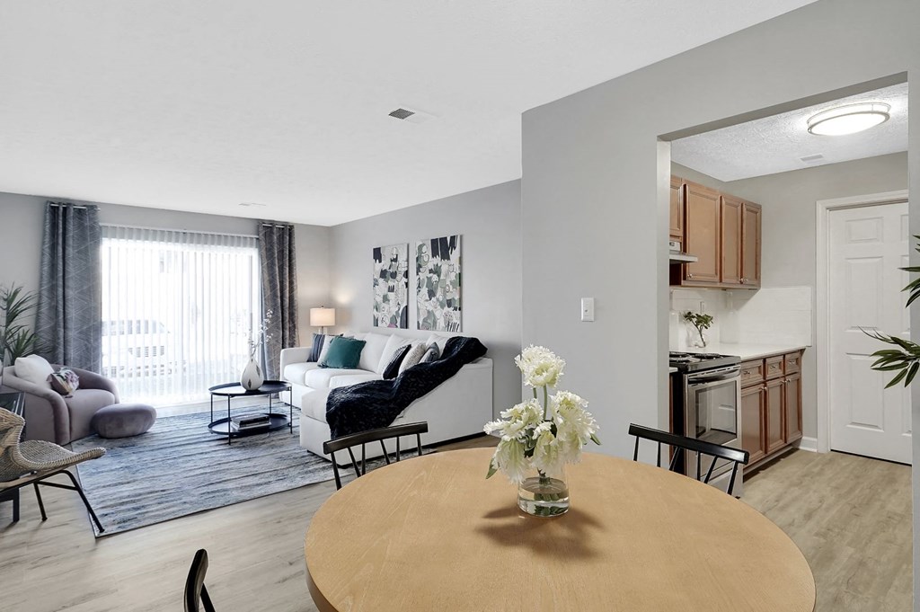 a dining room table with a vase  at Stonewater Apartments, Louisville, KY 40241of flowers on top of it