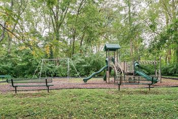 a playground with a swing set and a jungle gym at at Station JTown, Kentucky, 40299
