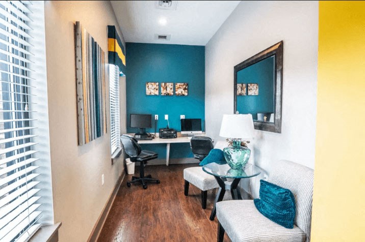 a room with a desk and two chairs and a large mirror at Enclave at Breckenridge Apartments, Louisville, KY