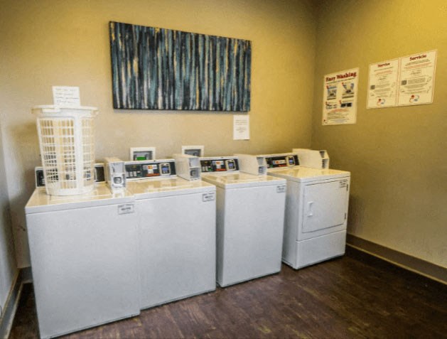 a row of washers and dryers in a room at Enclave at Breckenridge Apartments, Louisville, KY