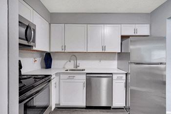 a kitchen with white cabinets and stainless steel appliances at Enclave at Breckenridge Apartments, Louisville, KY, 40220