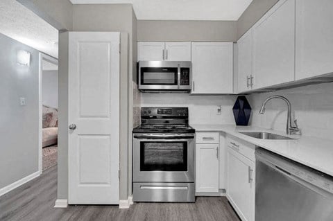 a kitchen with white cabinets and stainless steel appliances at Enclave at Breckenridge Apartments, Louisville, Kentucky