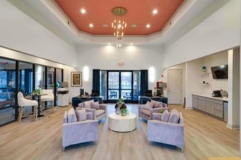 a clubhouse with couches and chairs and a table with a vase of flowers at Enclave at Breckenridge Apartments, Kentucky, 40220