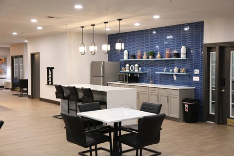 A modern kitchen with a dining table and chairs.