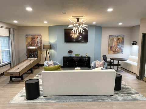 A modern living room with a white sofa and a black coffee table.