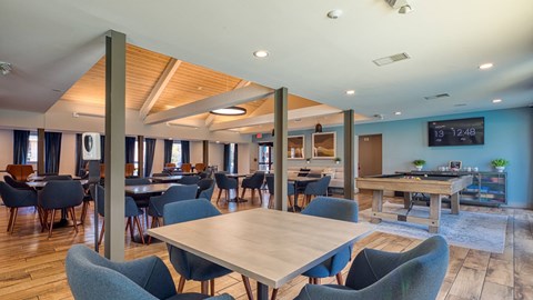 A modern dining area with wooden tables and chairs.
