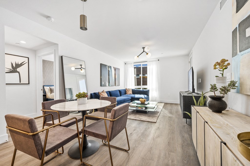 a living room with a table and chairs and a couch
