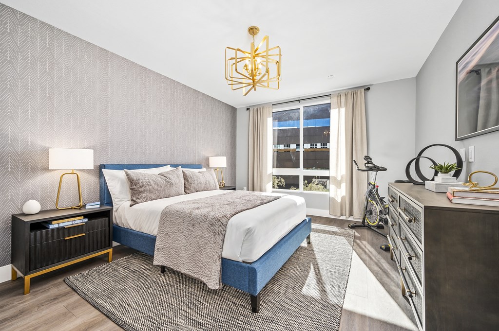 a bedroom with a bed and a large window