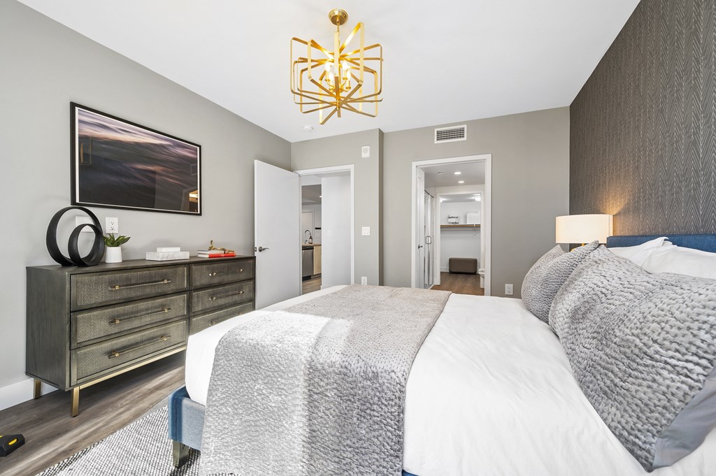 a bedroom with a large bed and a dresser