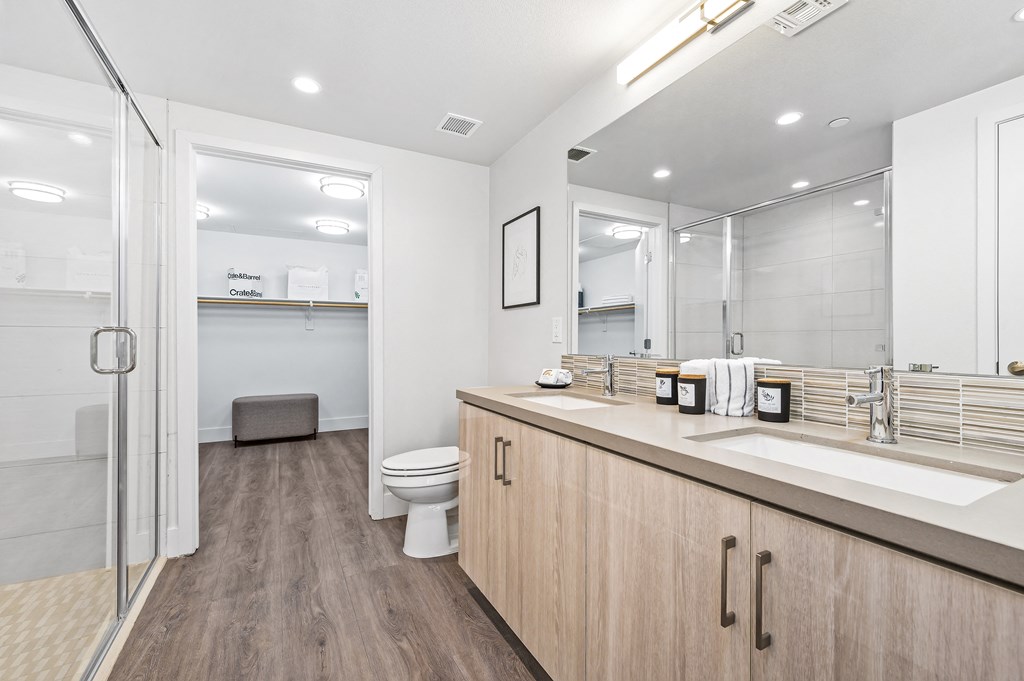 a bathroom with a sink and a shower and a toilet