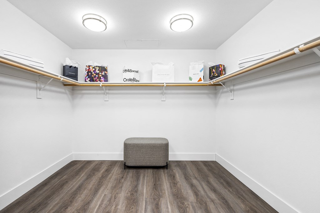 an empty room with a chair and a shelf on the wall