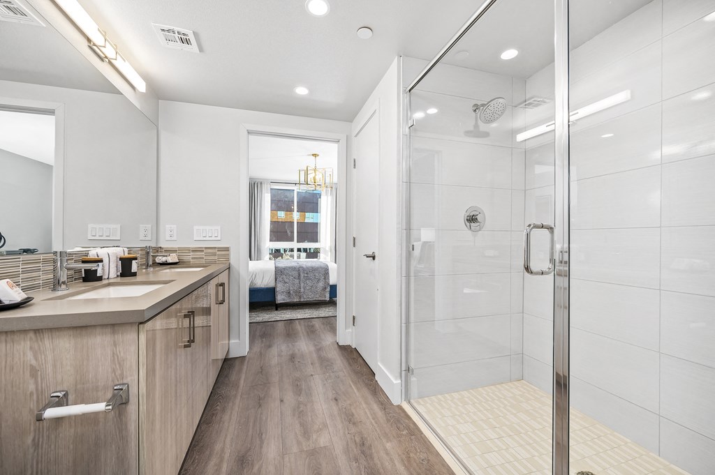 a bathroom with a shower and a sink and a mirror