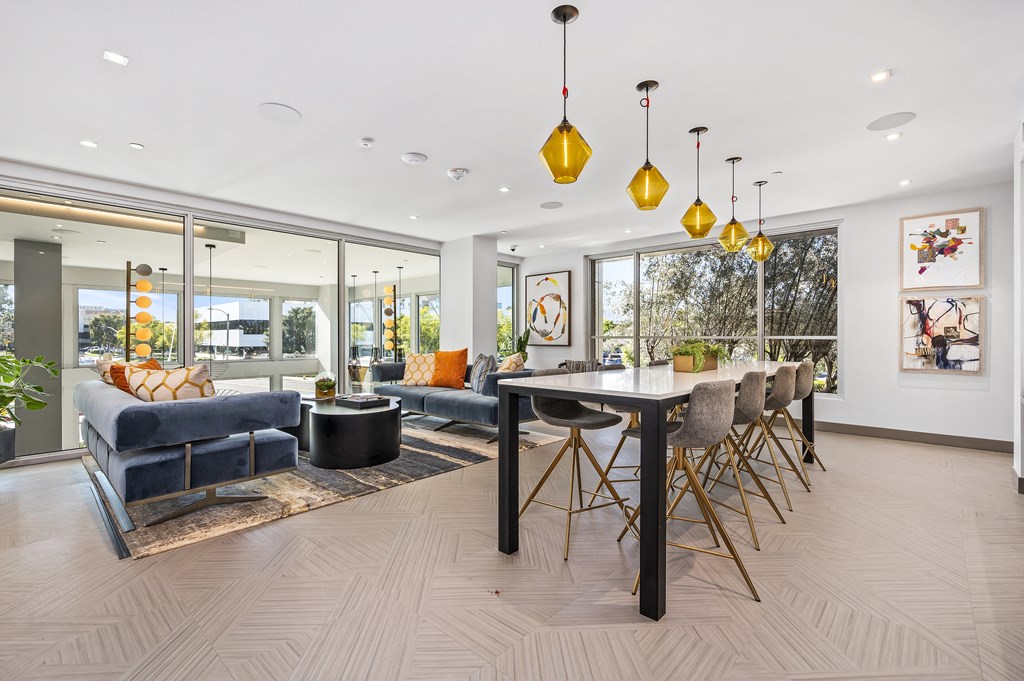 the living room has a large table with chairs and a couch