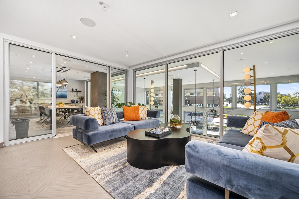 a living room with blue couches and a coffee table