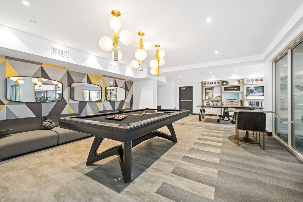 a games room with a pool table and a bar