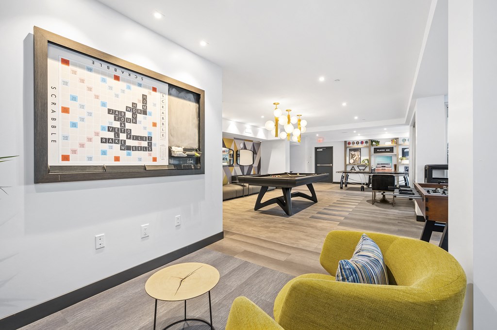 the preserve at ballantyne commons clubhouse with yellow furniture and a large bulletin board