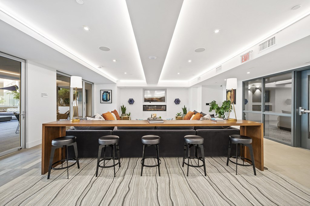 a large kitchen with a bar and stools