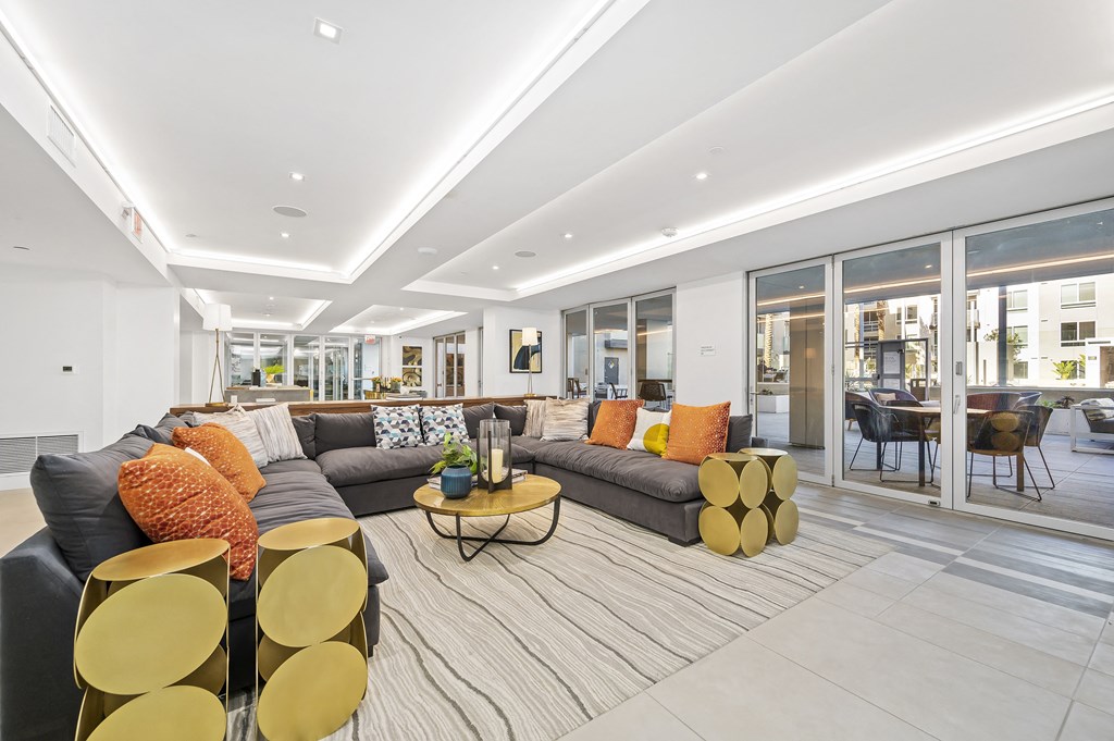 a living room with couches and chairs and a rug