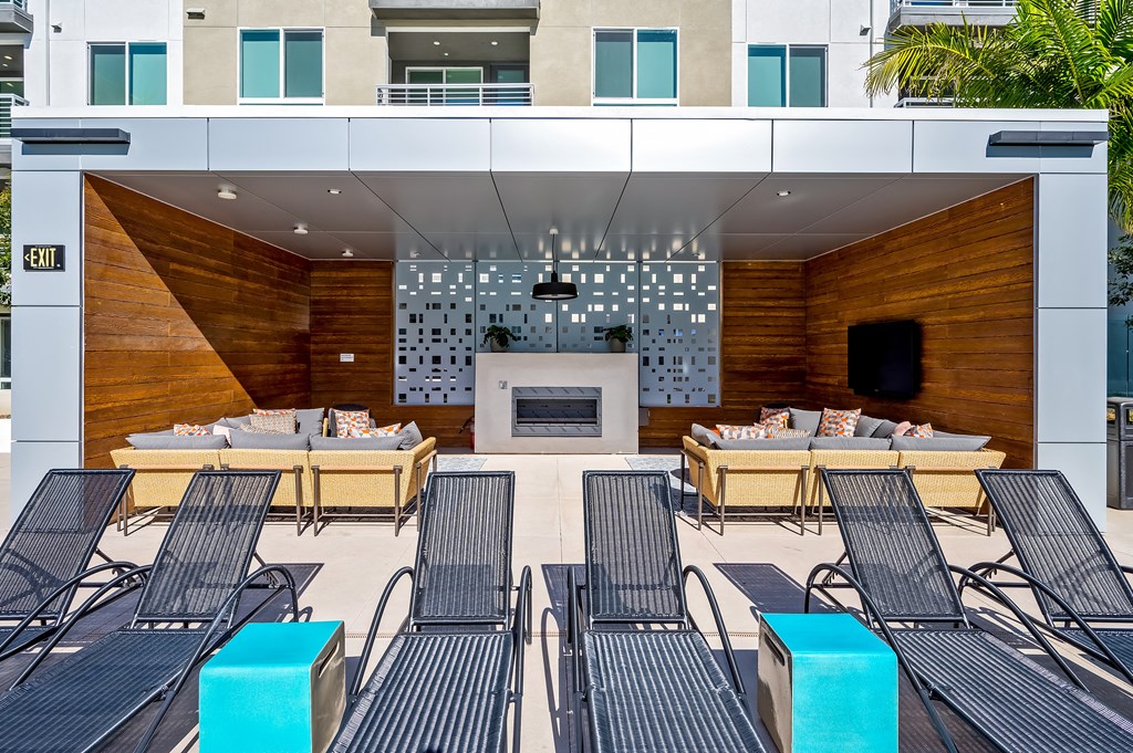 a lounge area with tables and chairs and a fireplace