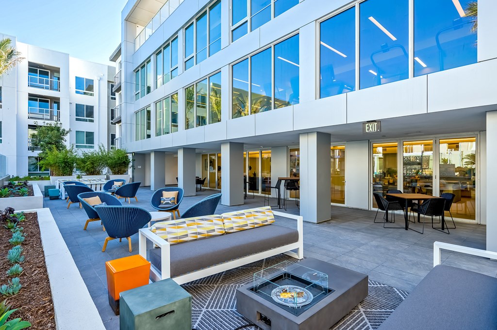an office building with a lobby with furniture and a fire pit