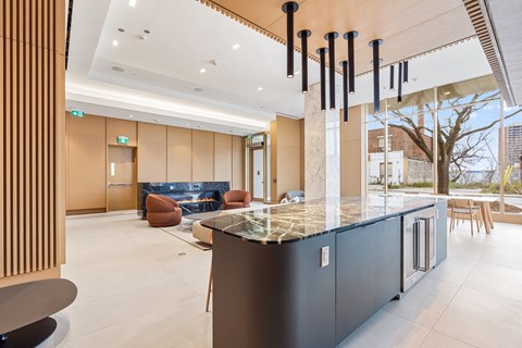 A modern kitchen with a black counter and a marble top.