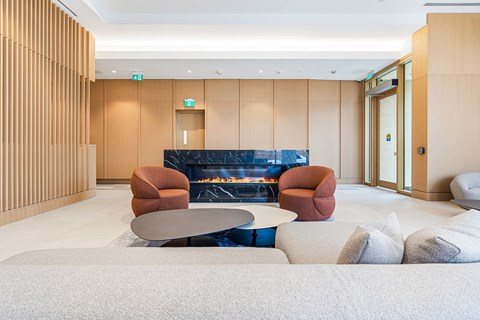 A modern living room with a fireplace and comfortable seating.