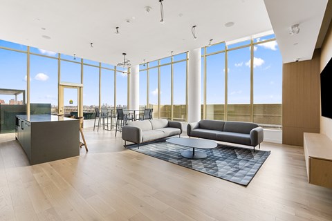 A modern living room with a large window and a view of the city.