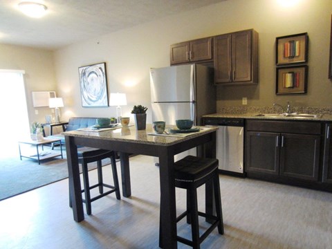 a kitchen and living room of an apartment