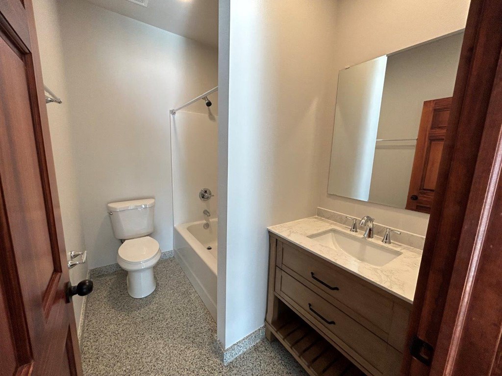 a bathroom with a toilet and a sink and a bath tub