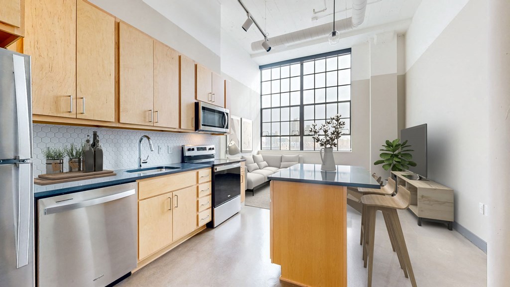 a kitchen with wooden cabinets and stainless steel appliances and a counter top