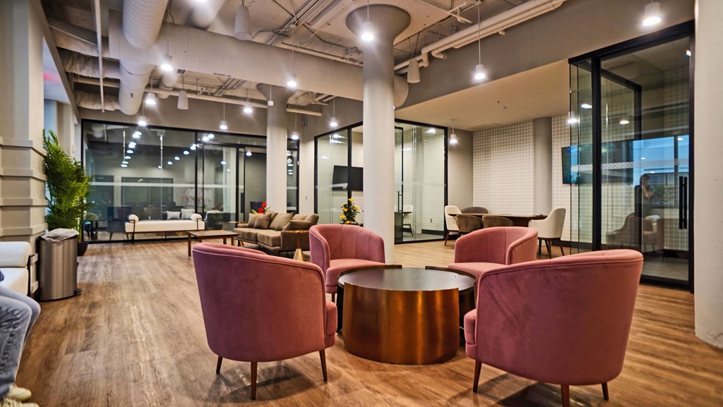 a lounge area with chairs and tables in a lobby