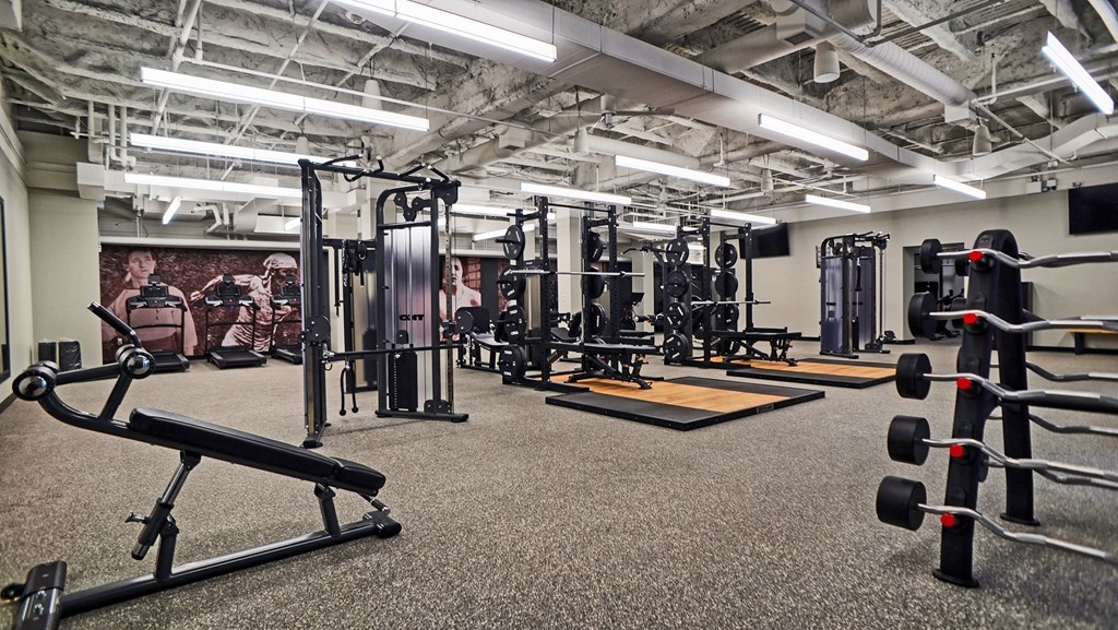 a fitness room with weights and other exercise equipment
