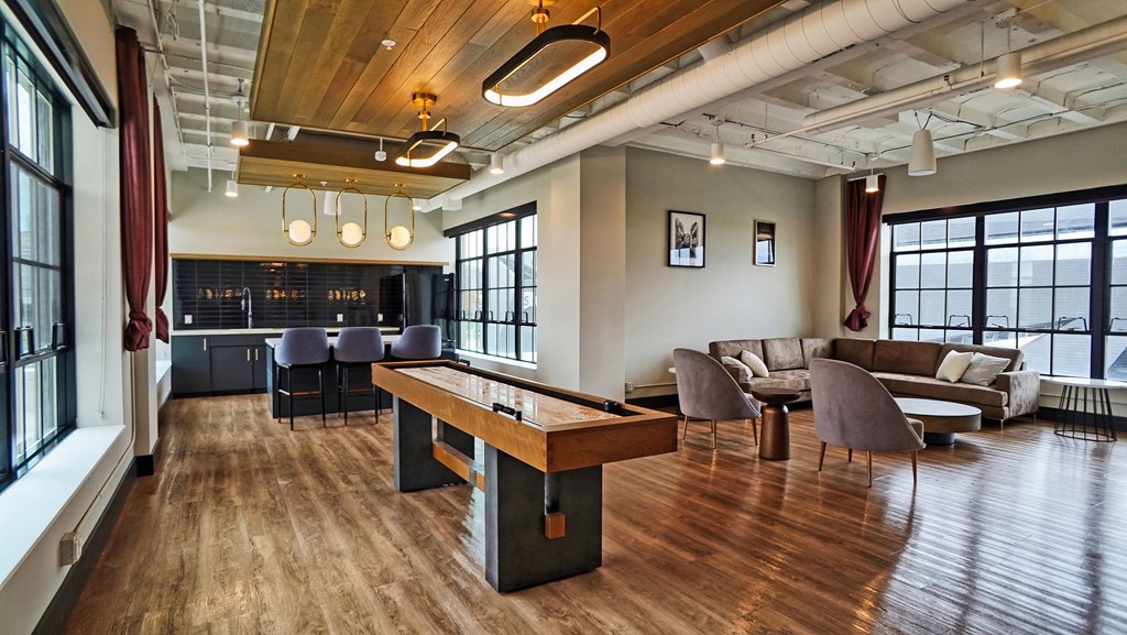 a living room with a pool table and couches