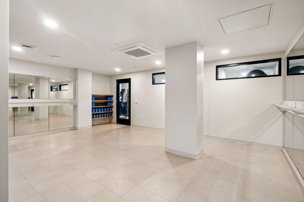 the interior of a large room with white walls and tile flooring
