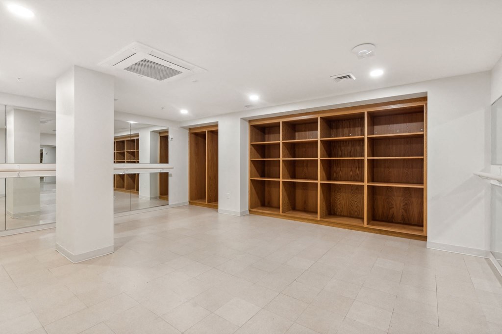 the living room has a large library with wooden shelves