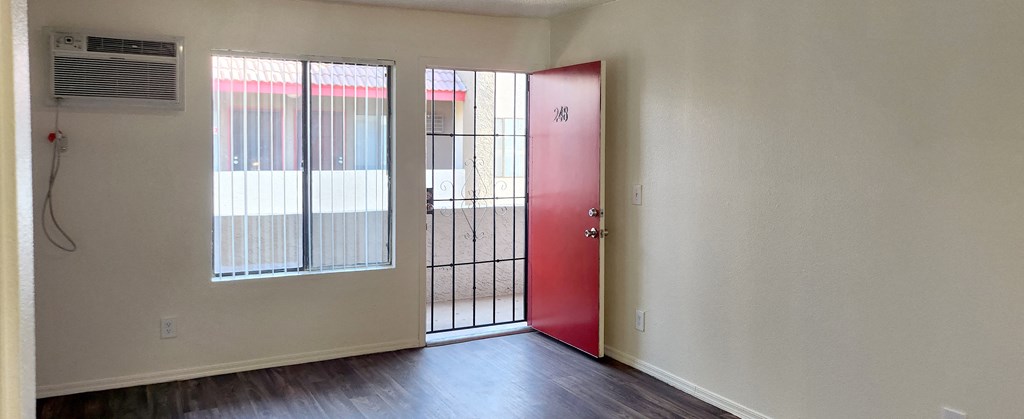 apartment entry way with a red door and window