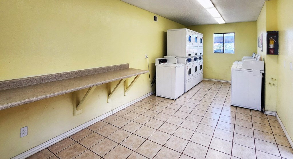 Common area laundry facility with counter space