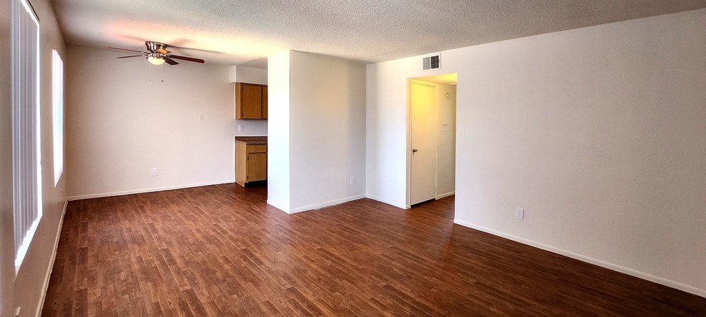 a bedroom with a ceiling fan and wood laminate floors