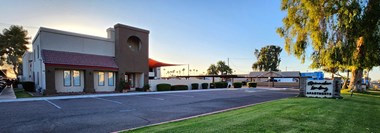 Lush green lawn in front of the leasing office at sunrise