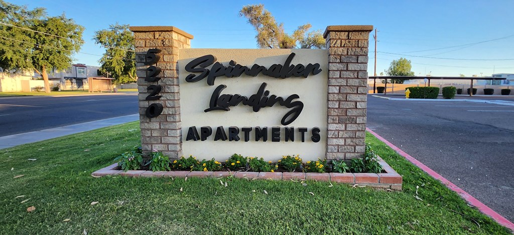 An exterior monument sign that reads Spinnaker Landing Apartments